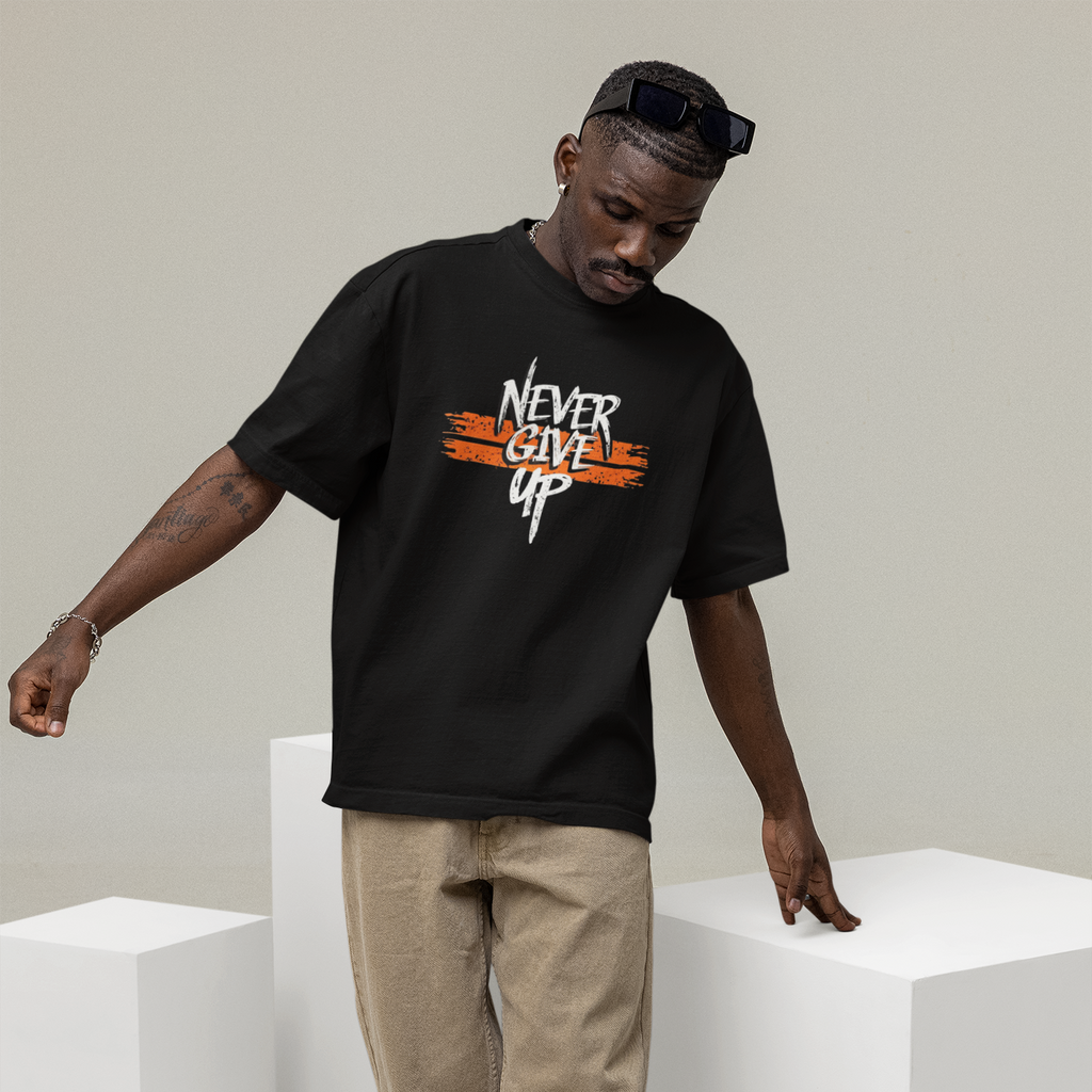 Man wearing a black t-shirt with 'Never Give Up' text, standing on white cubes against a plain background